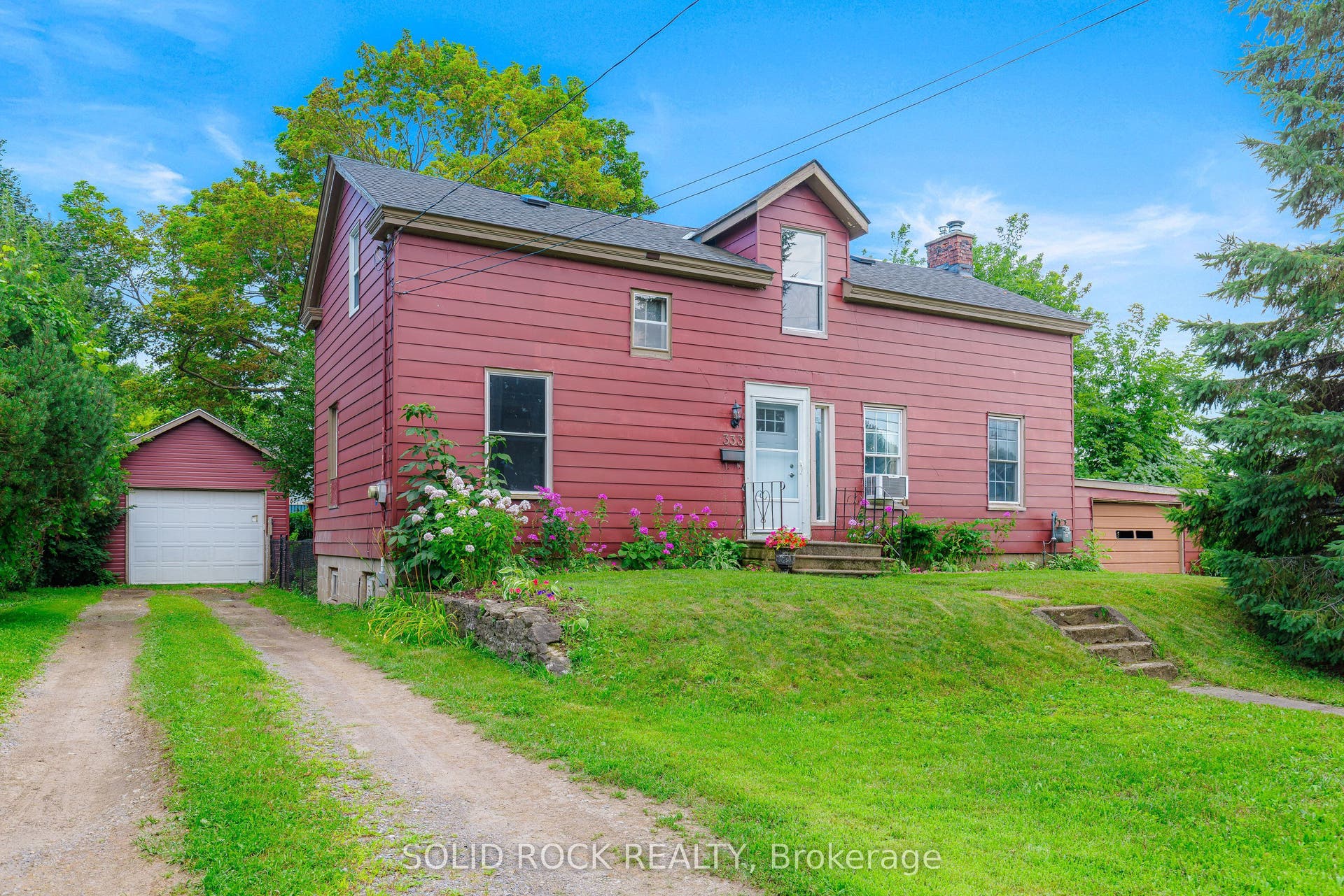 Detached garage on left, attached garage on right