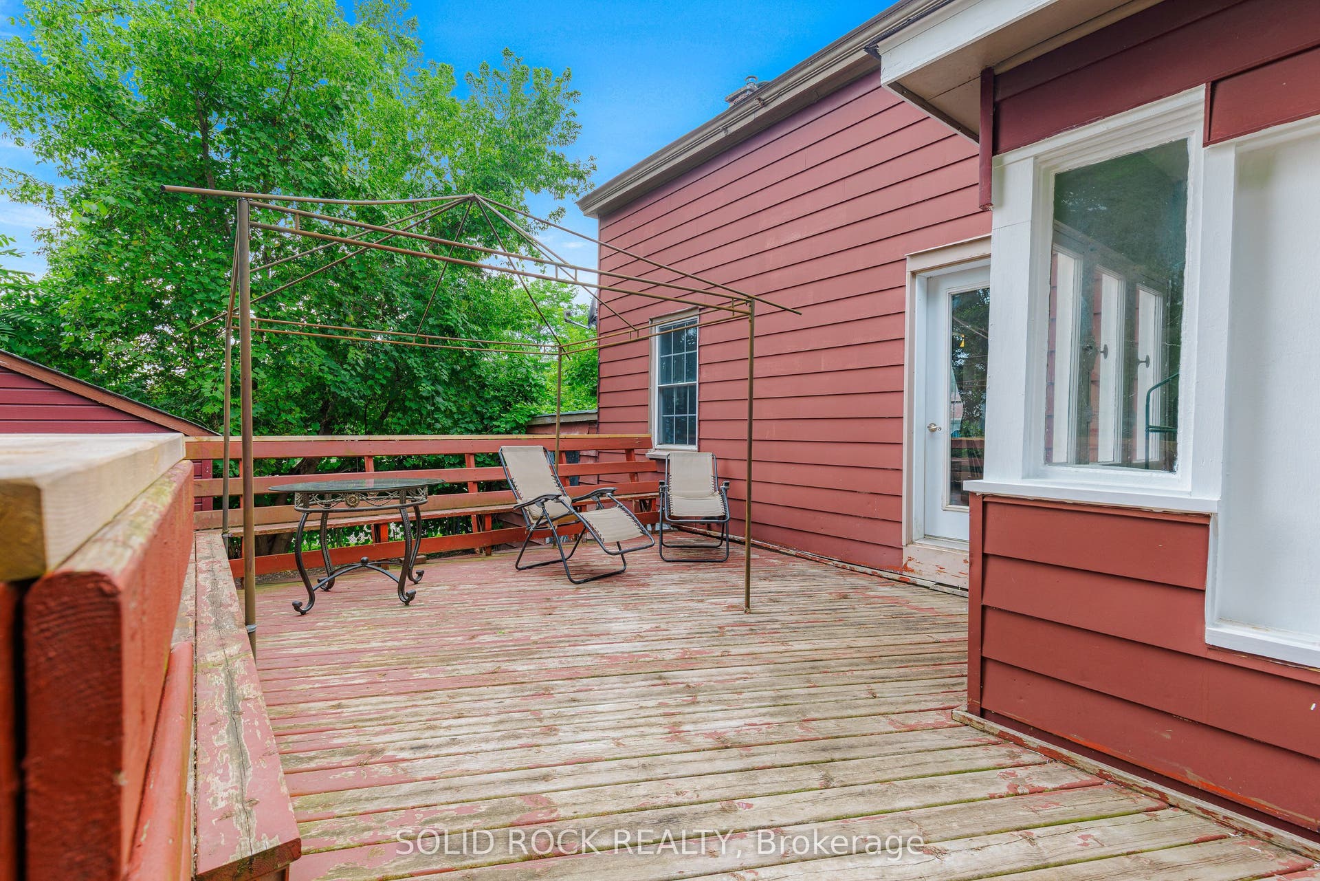 Huge rear deck with new railings, just add paint