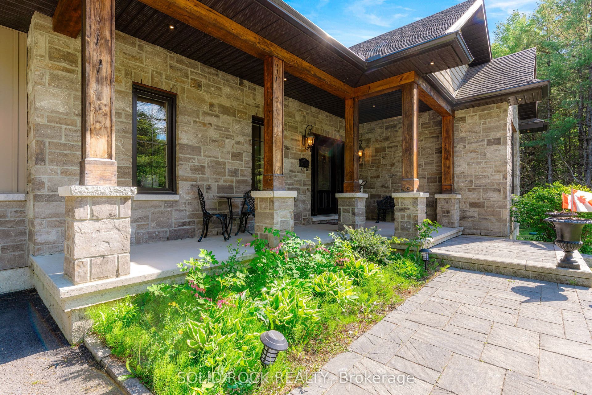 717 Upper Oak Leaf Road, Athens, Leeds And Grenville ON K0E 1B0 Stone and beam entryway with concrete patio.