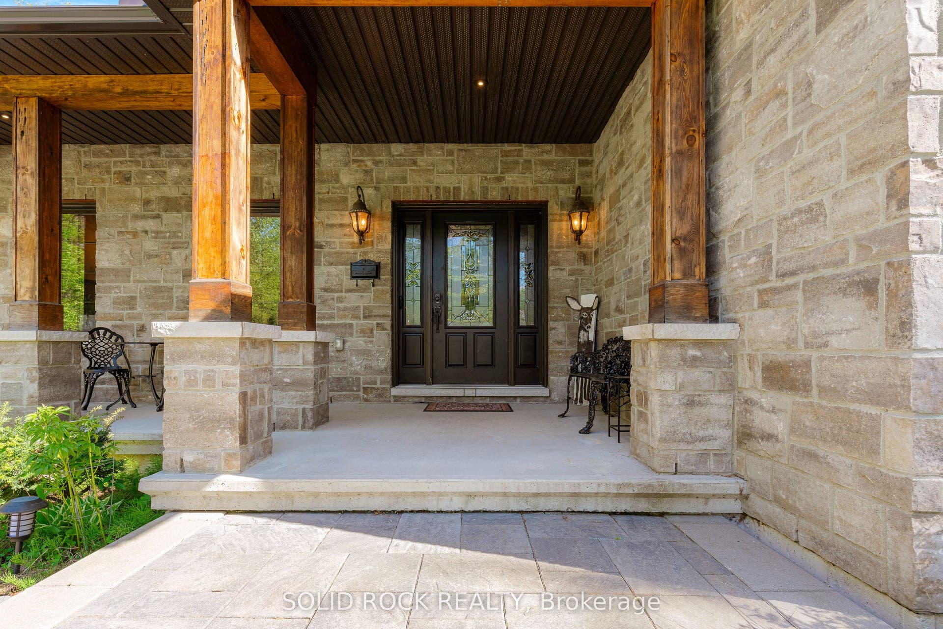 717 Upper Oak Leaf Road, Athens, Leeds And Grenville ON K0E 1B0 Stone and beam entryway with concrete patio.