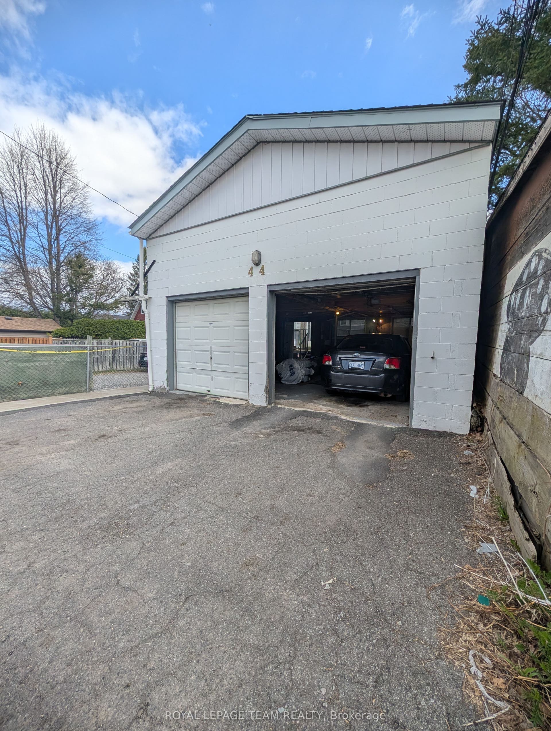 Parking in front of left garage door at rear