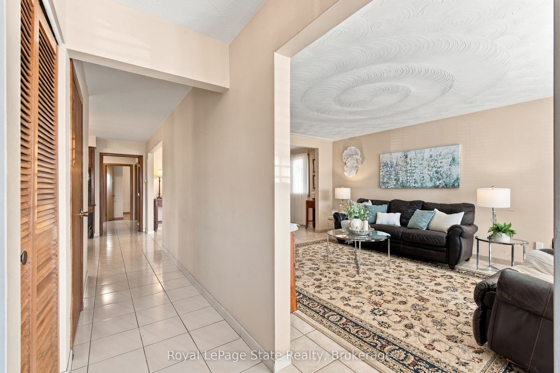 Entry with generous closet & neutral tile floors.