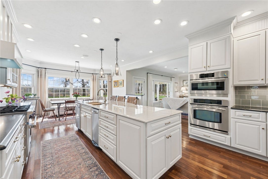 Mont Blanc natural Quartzite & Virginia Mist Black granite. 10.5 island with glass and wrought iron designer lighting.
Aged brass cabinet hardware