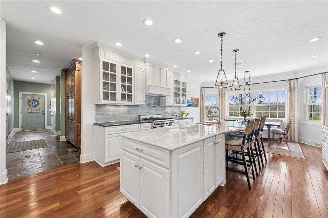 spectacular kitchen with sub zero refrig/freezer, 36" Wolf gas range, hard wood flooring, handmade glazed tiled backspash