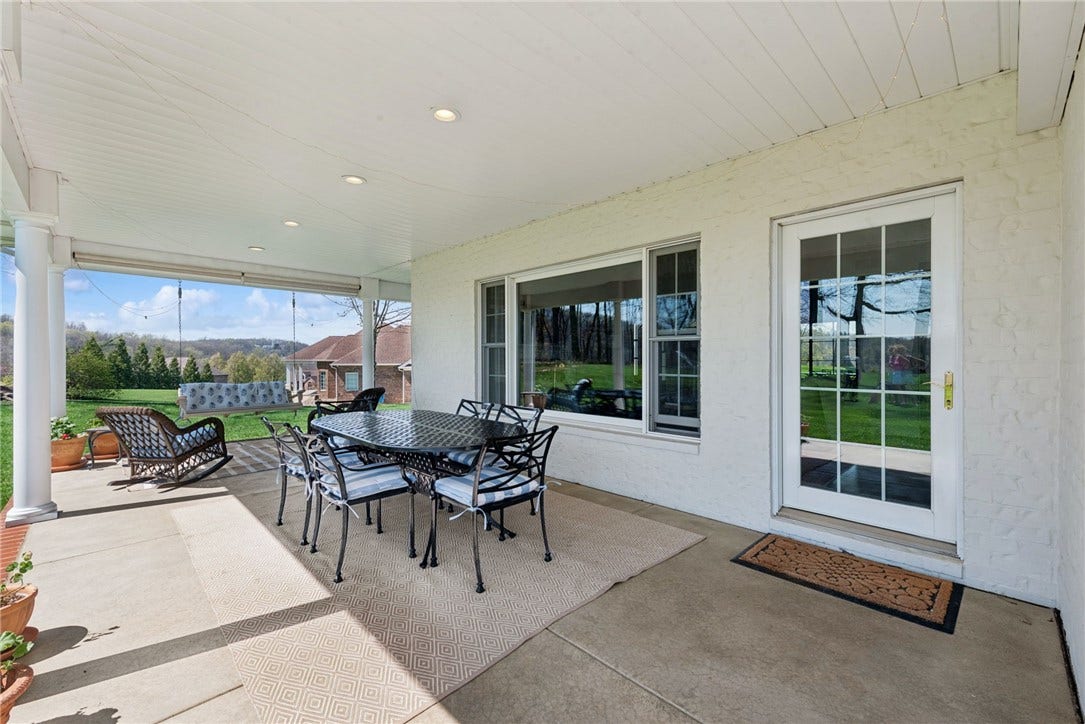 Wrap around covered porch in the rear of hte home