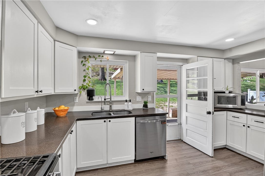 Light and Bright kitchen view with an exterior glimpse of the back yard.