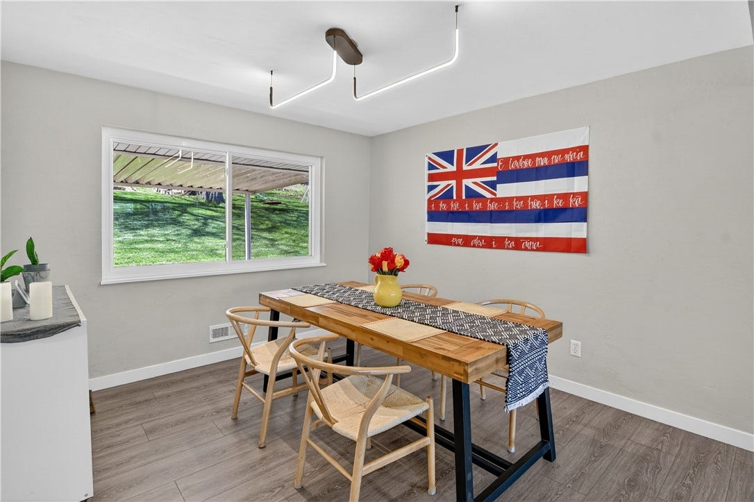 The light and bright dining room that proudly displays the Hawaiian flag