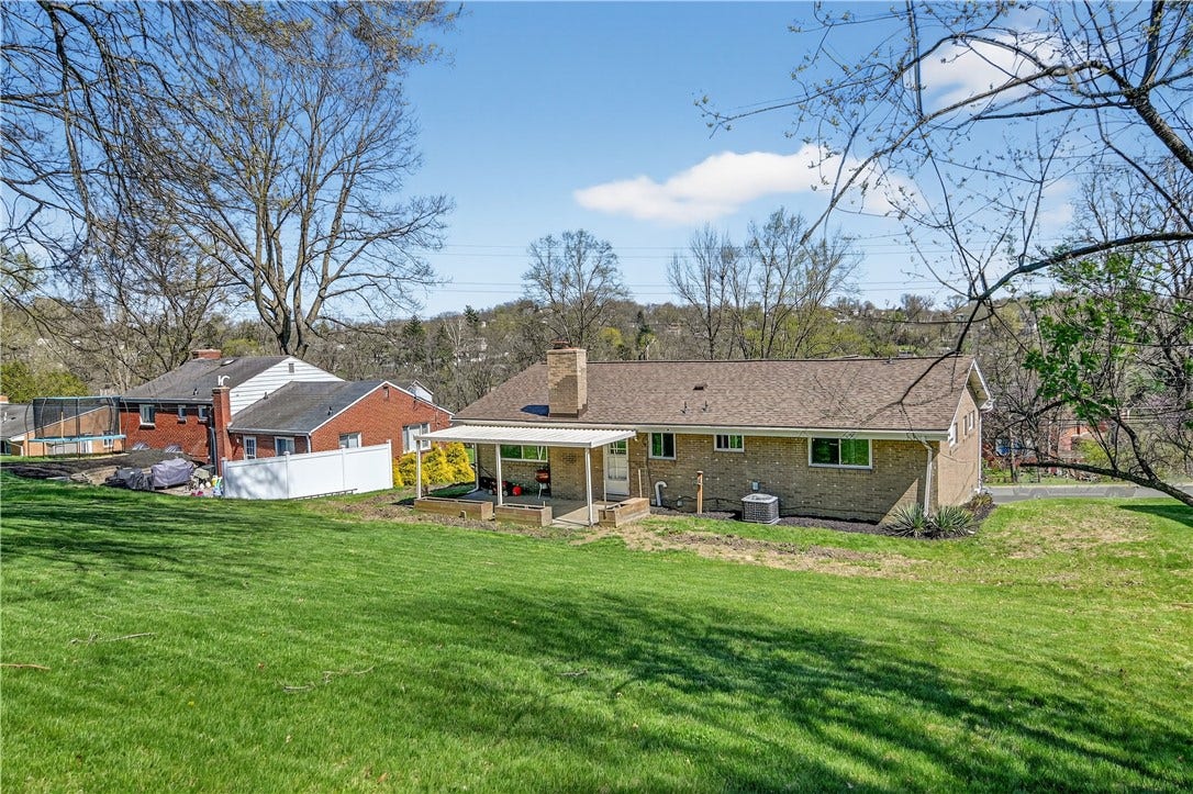 View of the back yard looking down at the rear of the home