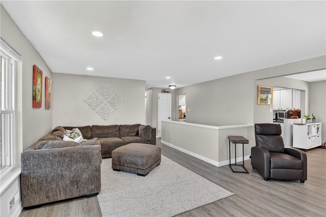 A view of the living room and part of the space leading into the kitchen