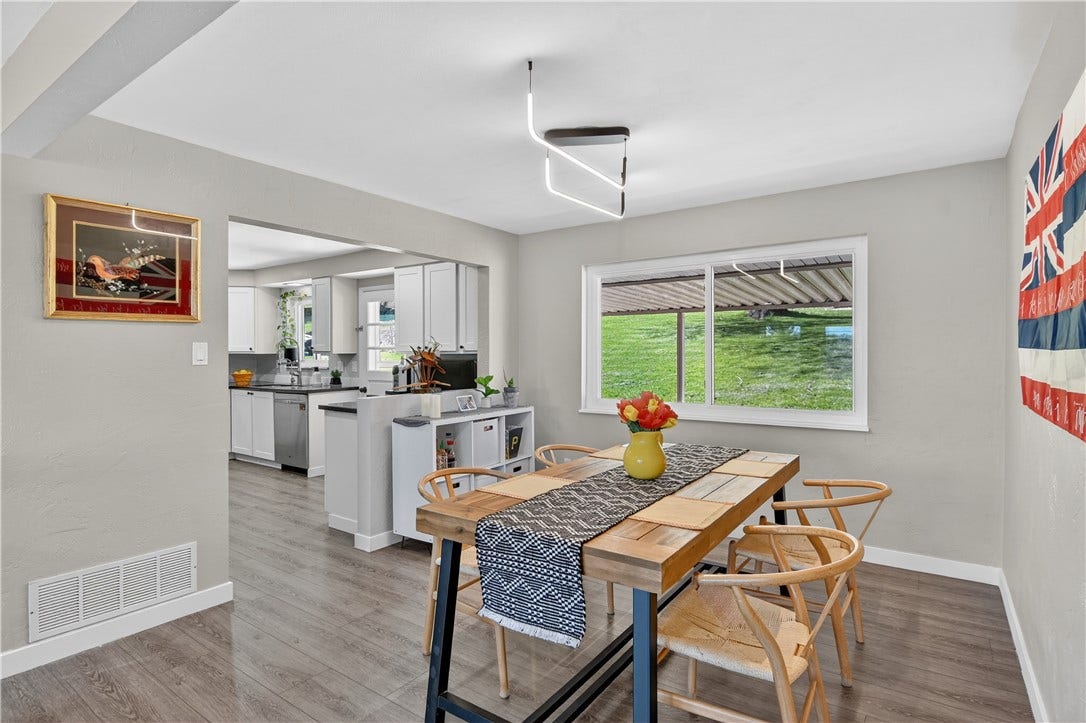 A great view of the light and bright dining room that also shows the newer LVP flooring that has been installed in most of the main level living areas as well as the LL living areas