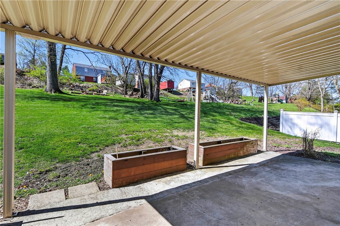 Covered patio overlooking part of the back yard