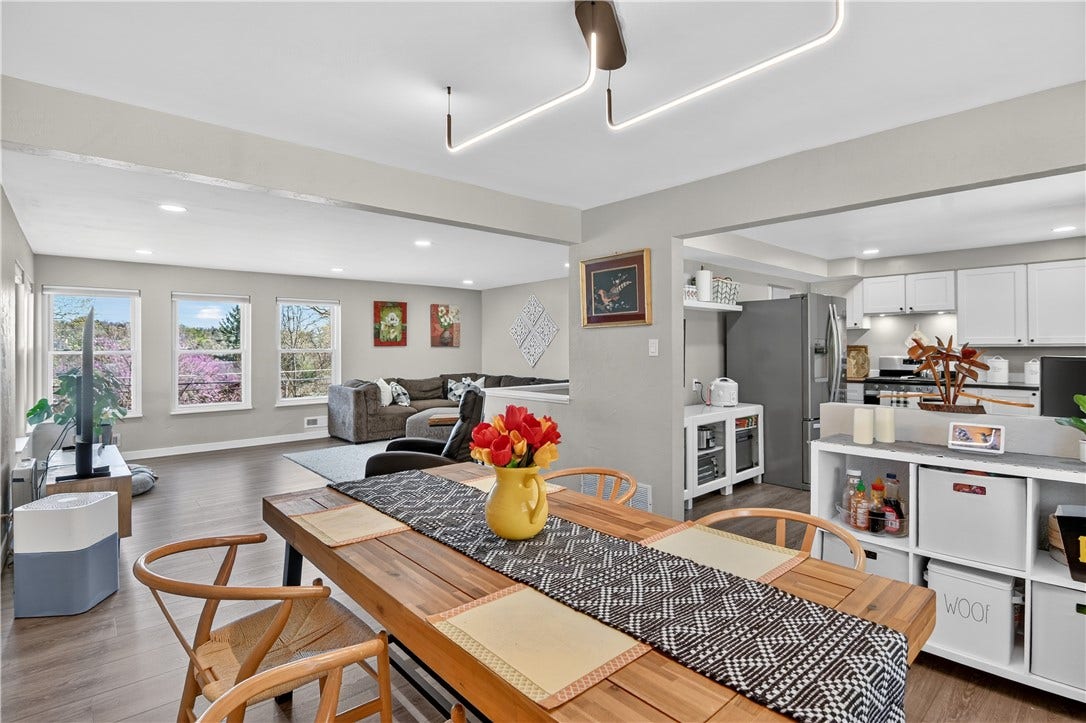 A great view of the dining room, living room and kitchen spaces