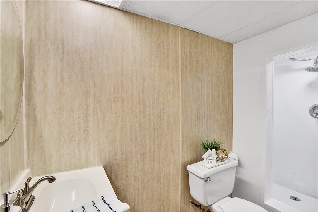 Situated on the lower level, nice bathfitter stand up shower!