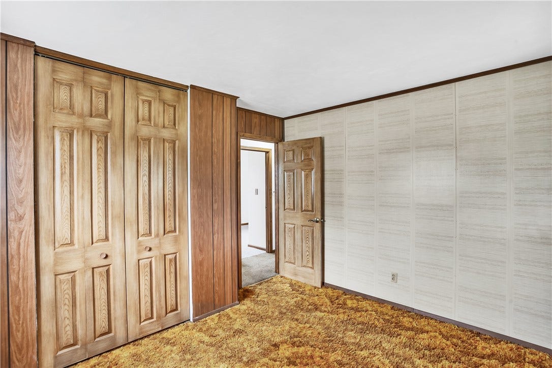 Would look fabulous with the hardwoods exposed and a fresh coat of paint.  Look at those doors!