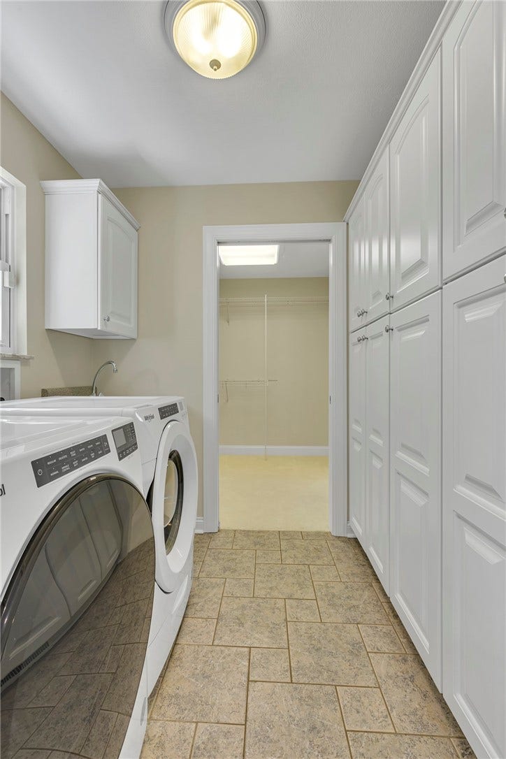 The first-floor laundry is complete with a utility sink and floor to ceiling pantry.
