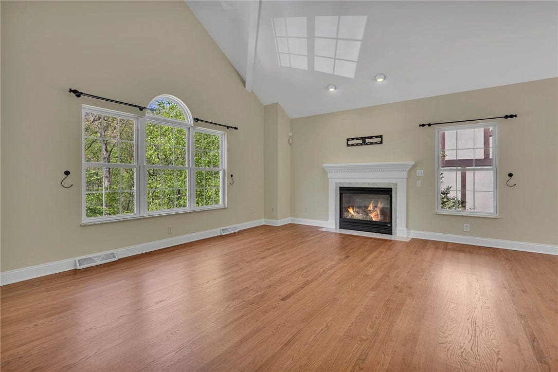 Elevated from street level the living room is bright and airy with architectural details and refinished hardwood floors.
