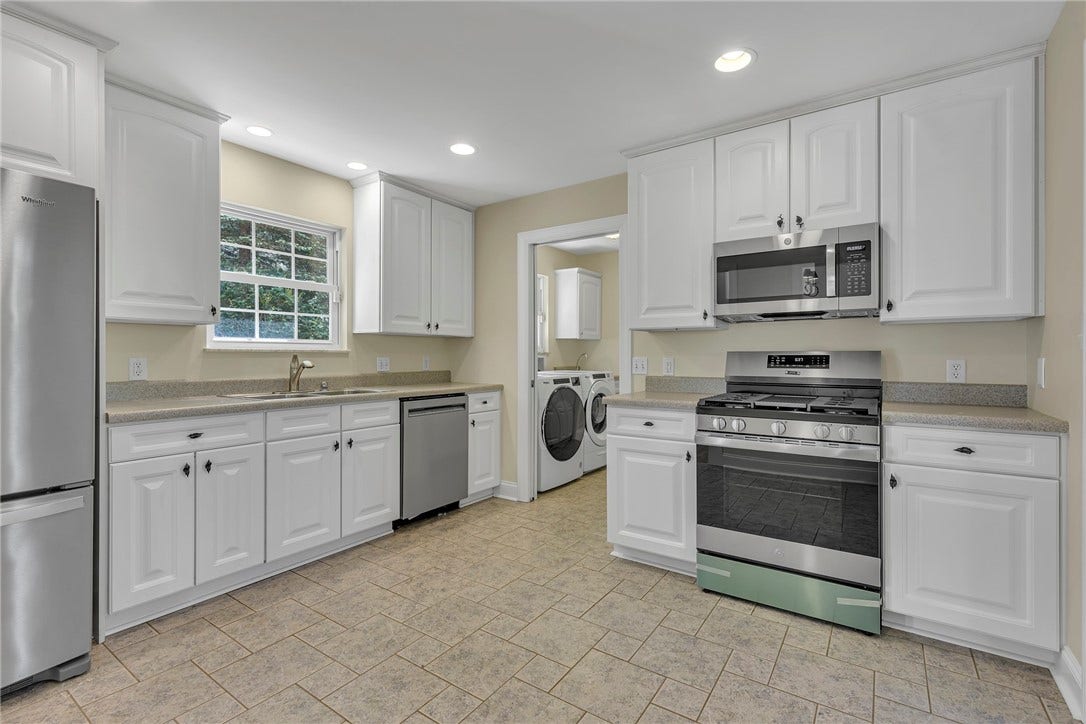 The kitchen leads to the over-sized pantry opposite the laundry area.