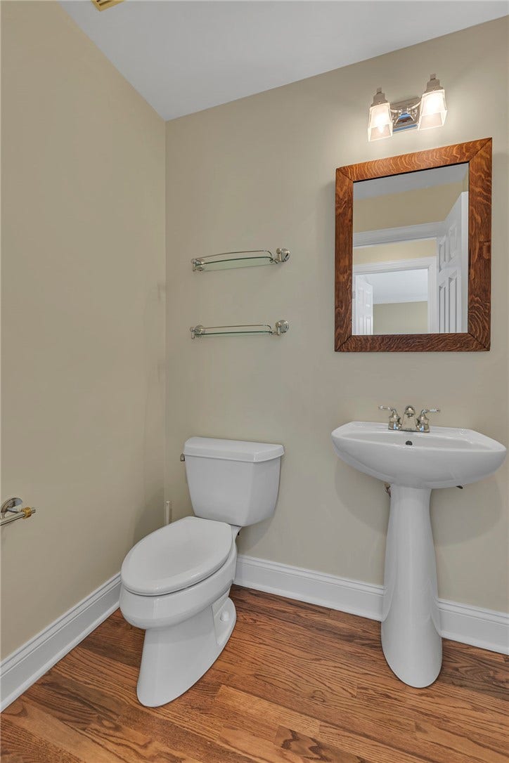 Hardwood floors continue into the first level powder room.