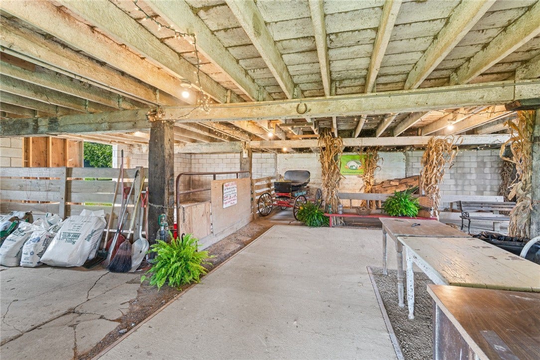 Multiple barns provide flexible space for horses, equipment, hay, and farm operations.