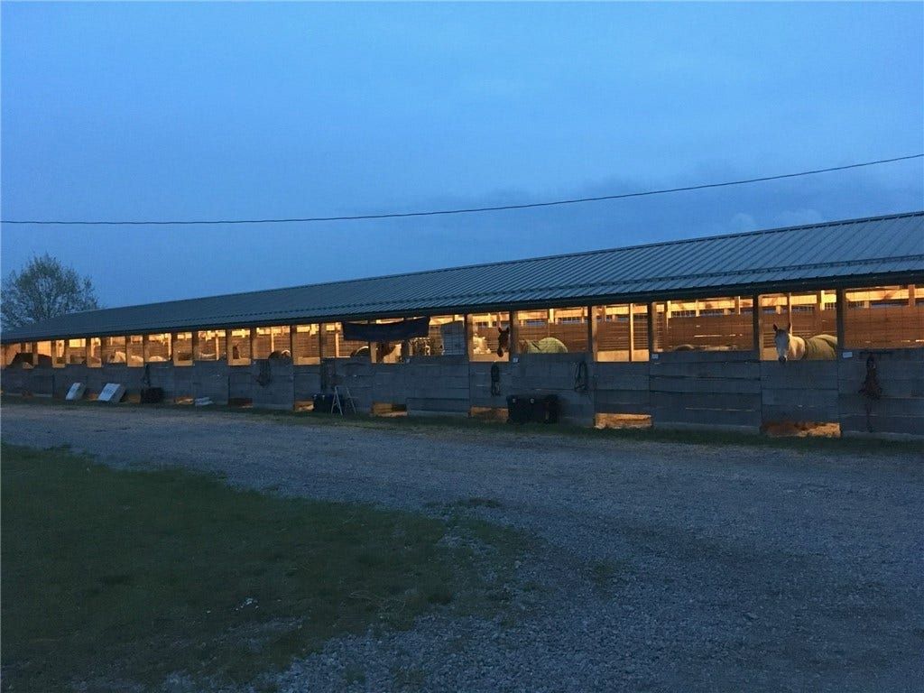 The barns offer strong boarding potential for private or professional equestrian use.