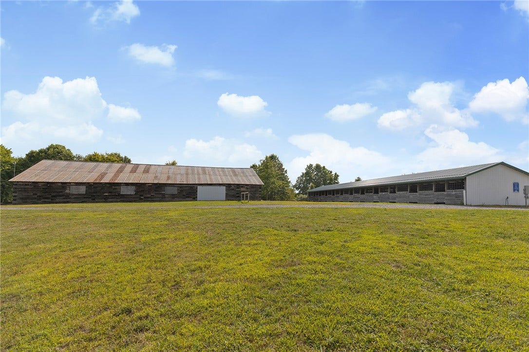 Multiple barns offer flexibility for boarding, training, storage, or farm use.