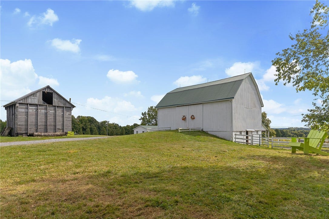 Spacious barns offer endless possibilities for equestrian, agricultural, or event use.