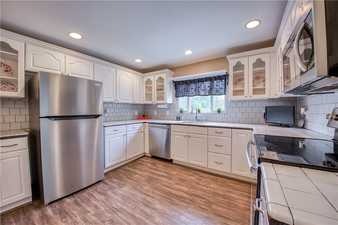 Kitchen with hardwood floors and stainless steel appliances