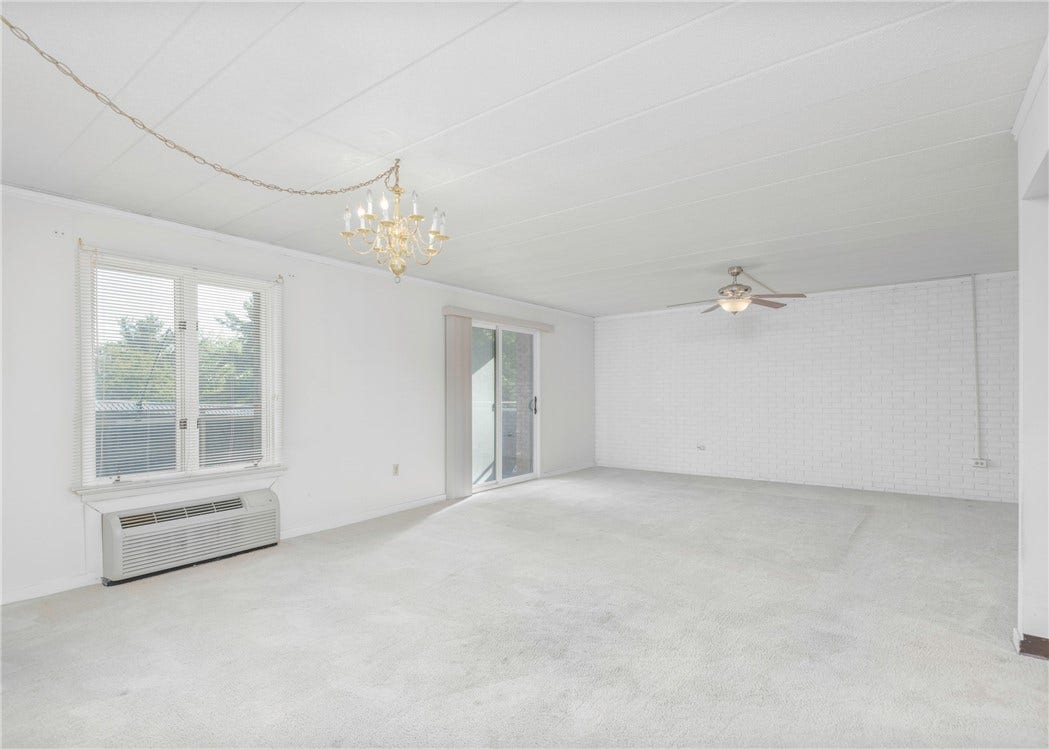 Living/Dining are with view of sliding door to balcony.
