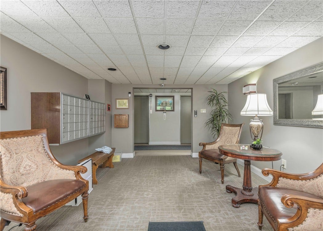 Secure entrance area accessible by key only.  Mailboxs located left.