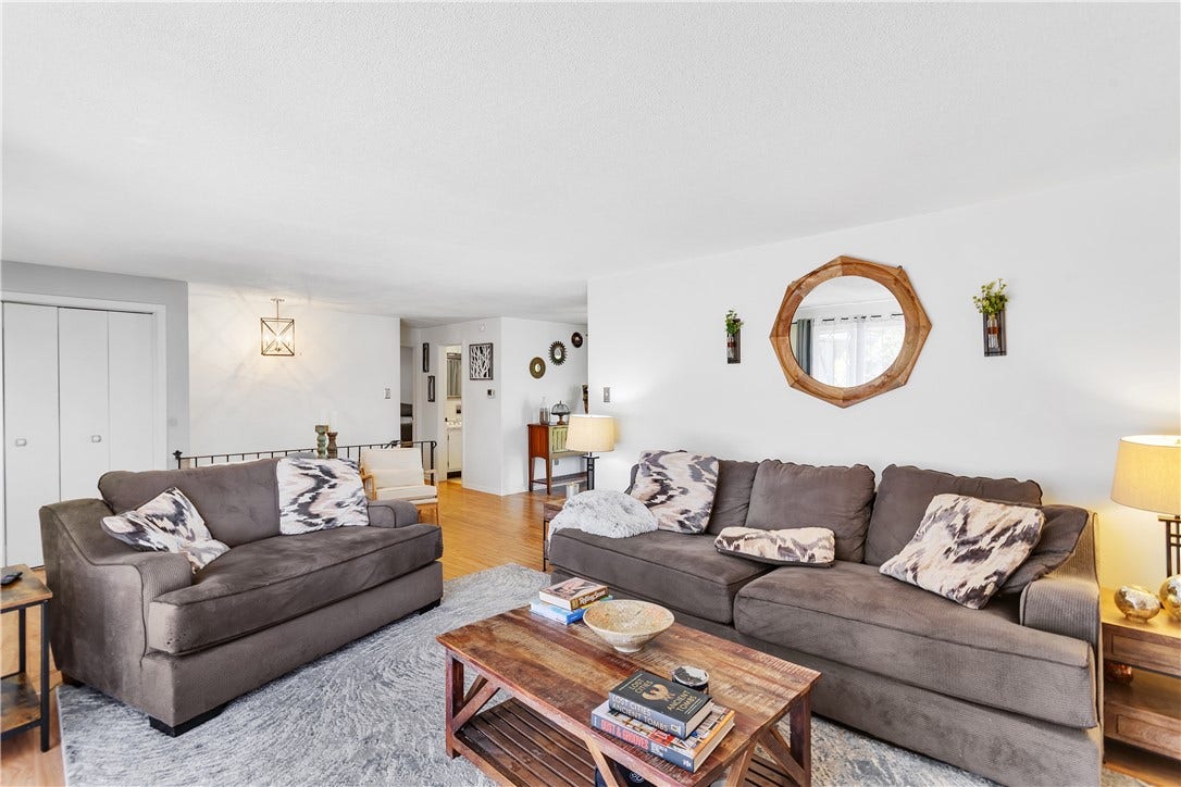 22x12 Living Room off the Entry with Double Coat Closet and Open Railing to Lower Level.