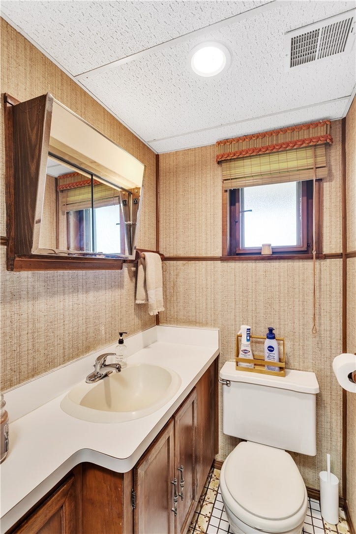 Full Bath on Finished Lower Level with Retro Tile Floor, Fiberglass Shower Unity and Vanity with Extended Counter Space. Plus an Old School Medicine Cabinet!