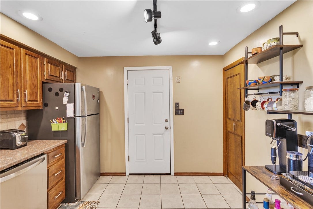 Door from the 13x9 Kitchen Opens into the Spacious Attached Garage. Built in Shelves will Stay.