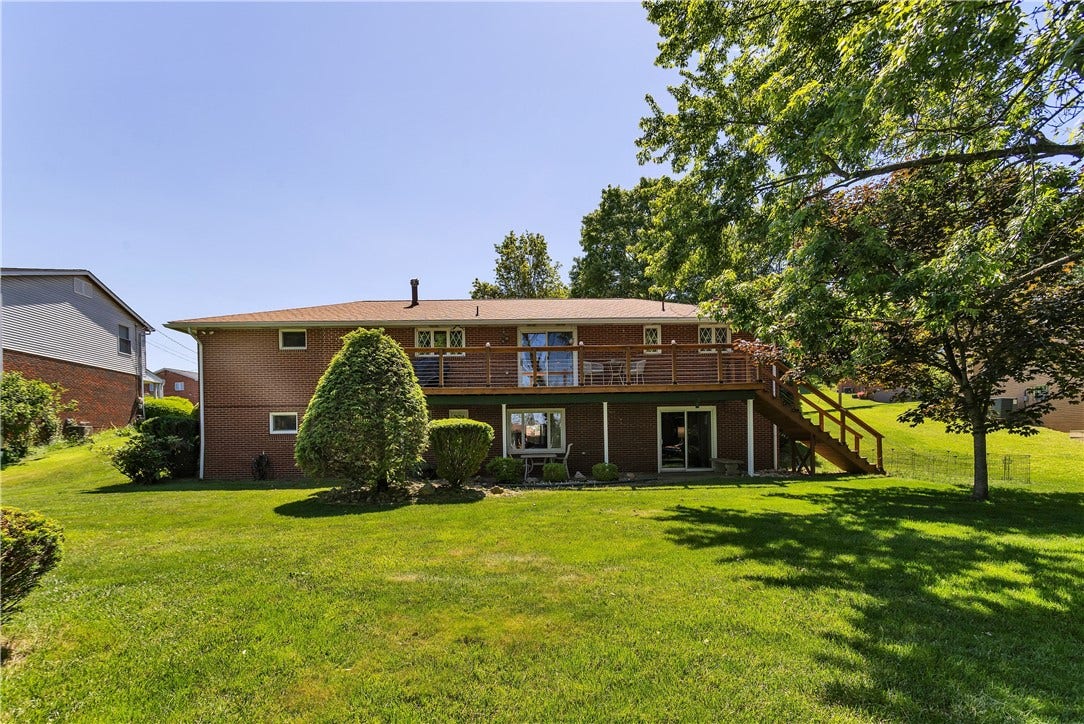 Don't Miss this OVERSIZED Ranch Home with Level Yard and Two Potential Living Spaces!