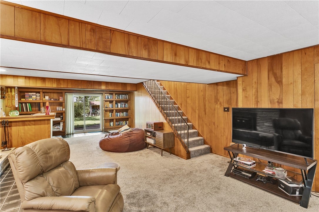 Newer Carpet and Sliding Glass Door, Built in Bookshelves, and an Open Railing Make this Space Warm and Inviting.