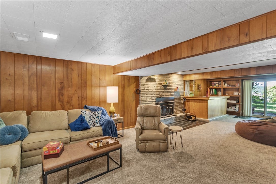 35x17, Finished Lower Level Family/Game Room with Wood Burning Stove with Stone Surround, Concrete Mantle and Hearth.