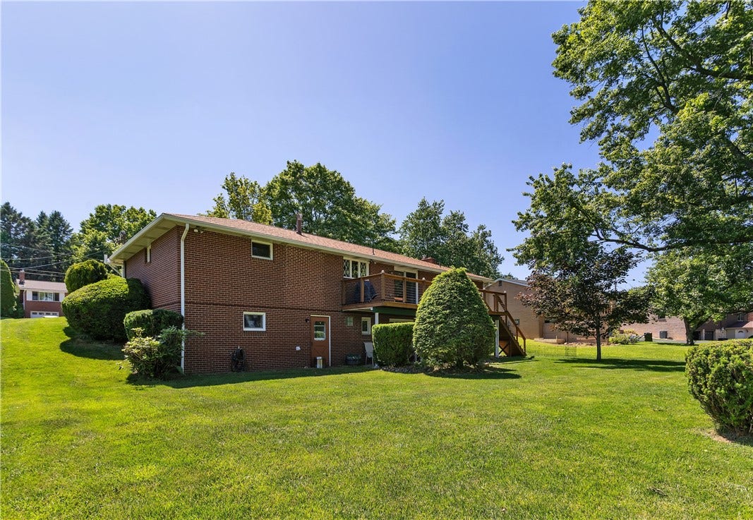All Brick Sides and Rear and Level Yard with Lots of Green Space.