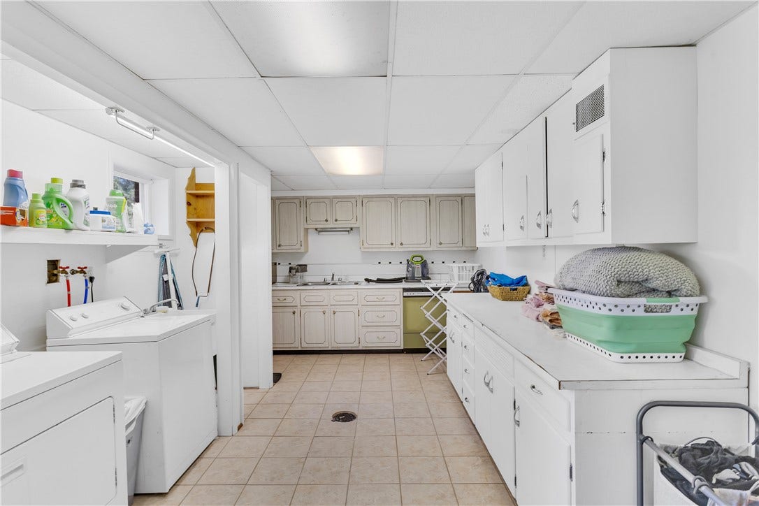 18x11 Laundry / Kitchenette with Washer/Dryer/Utility Sink, Tile Floor, Ample Cabinetry, Double Sink, Dishwasher, and Large Double Closet Next to a Walkout fromt the Laundry Area.