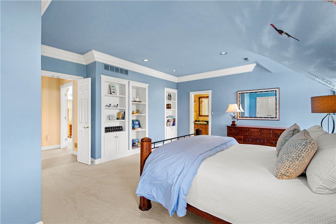 Another view of the bedroom shows the built in shelves.