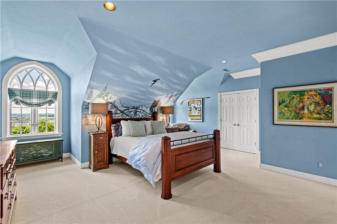 spacious bedroom with a large closet and a built-in wall unit just out of sight.