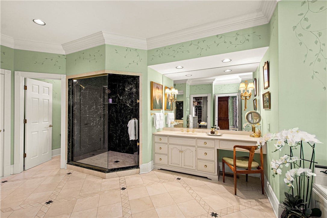 Custom marble floors and a marble tiled shower with Jolie filtered shower heads.