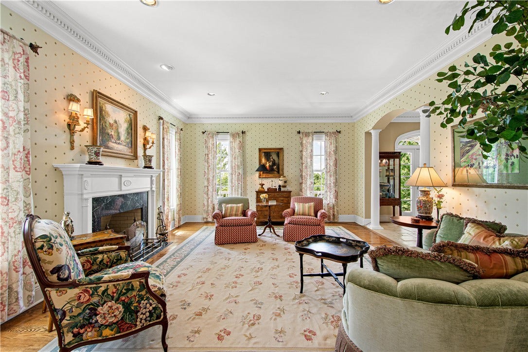 This inviting space provides ample room for entertaining. The fireplace is a focal point of this gracious room.