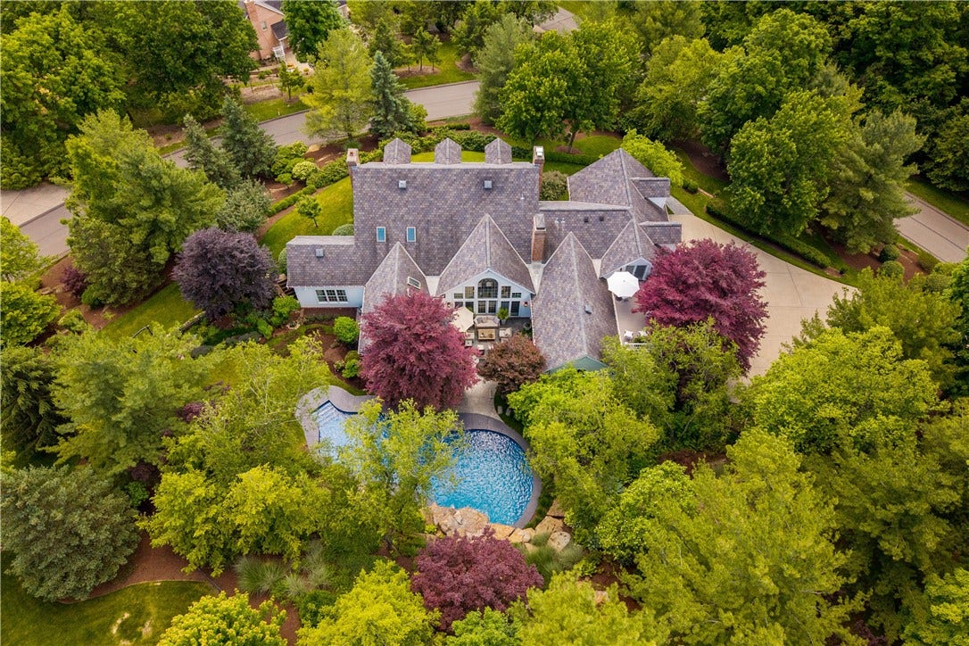 The aerial view captures the various roof lines and the scale of this home.