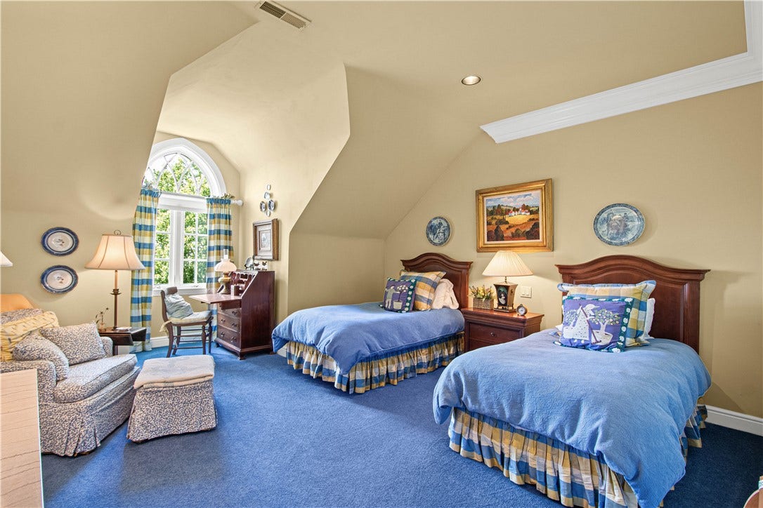 Beautiful celling lines and a double Palladian window creates architectural charm to this bedroom which is connected to a private bathroom.