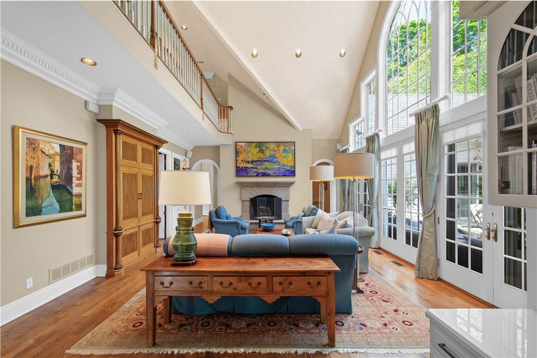 Soaring 20ft. ceilings (with UVA/UVB protection) and Windows provide a dramatic backdrop for the Family Room.The fireplace features volcanic rock facade and a raised heath.