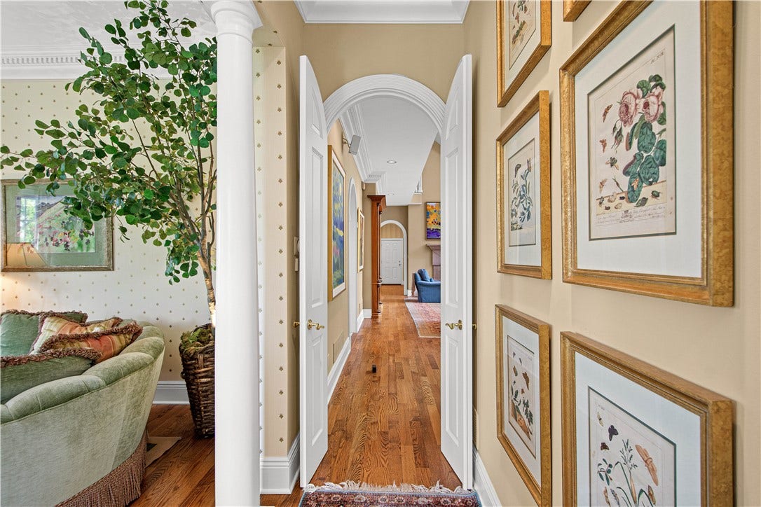 Even the hallways offer unique architectural detail. The carved moldings and doors exemplify the attendtion to detail you will find throughout this home.