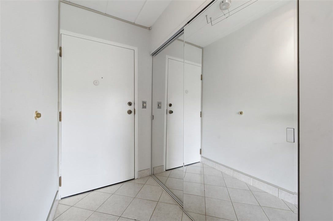 1400 Smokey Wood Dr, #601, Pittsburgh, PA 15218 Upon entry, you're welcomed by a spacious foyer featuring a large coat closet with mirrored doors and clean white ceramic tile flooring.