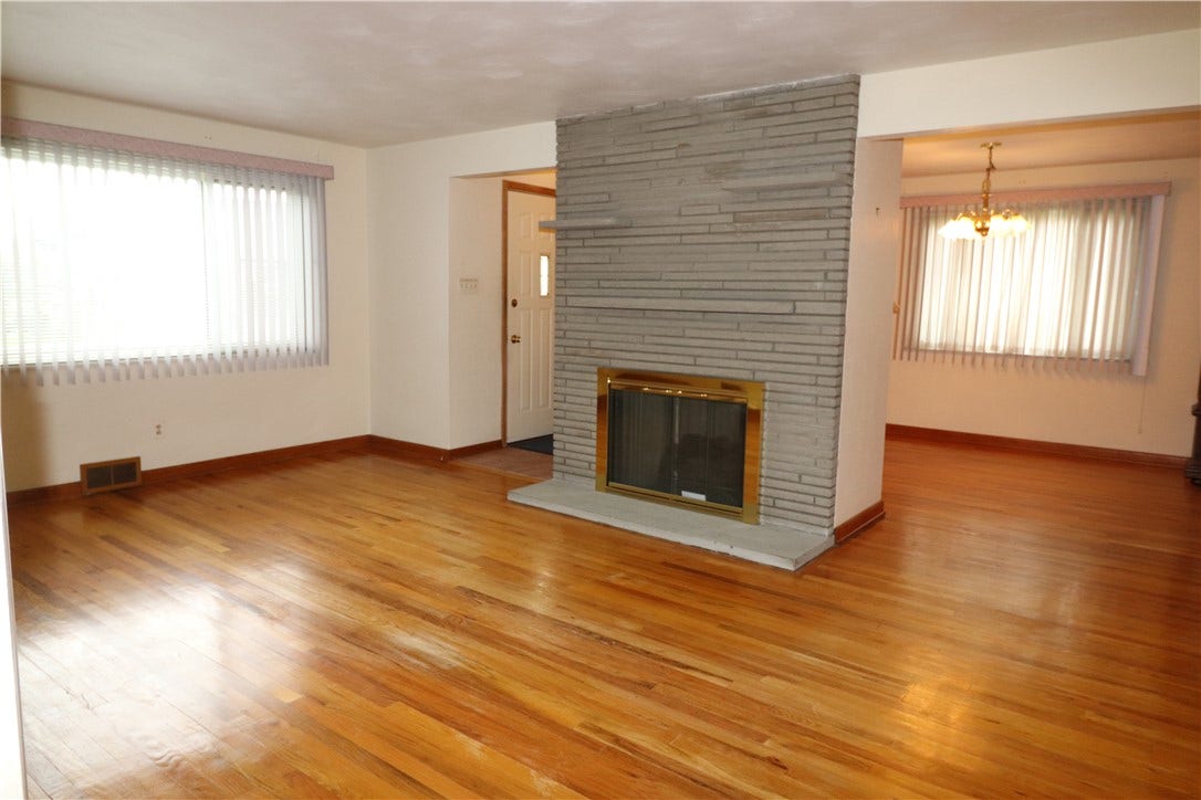 The gorgeous fireplace separates the living room and dining room.