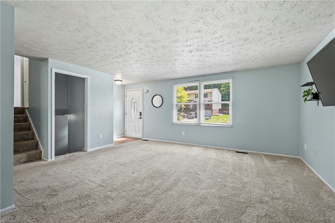 Enter the spacious living room with an entry closet.