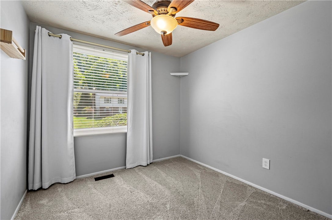 Third bedroom with lighted ceiling fan.