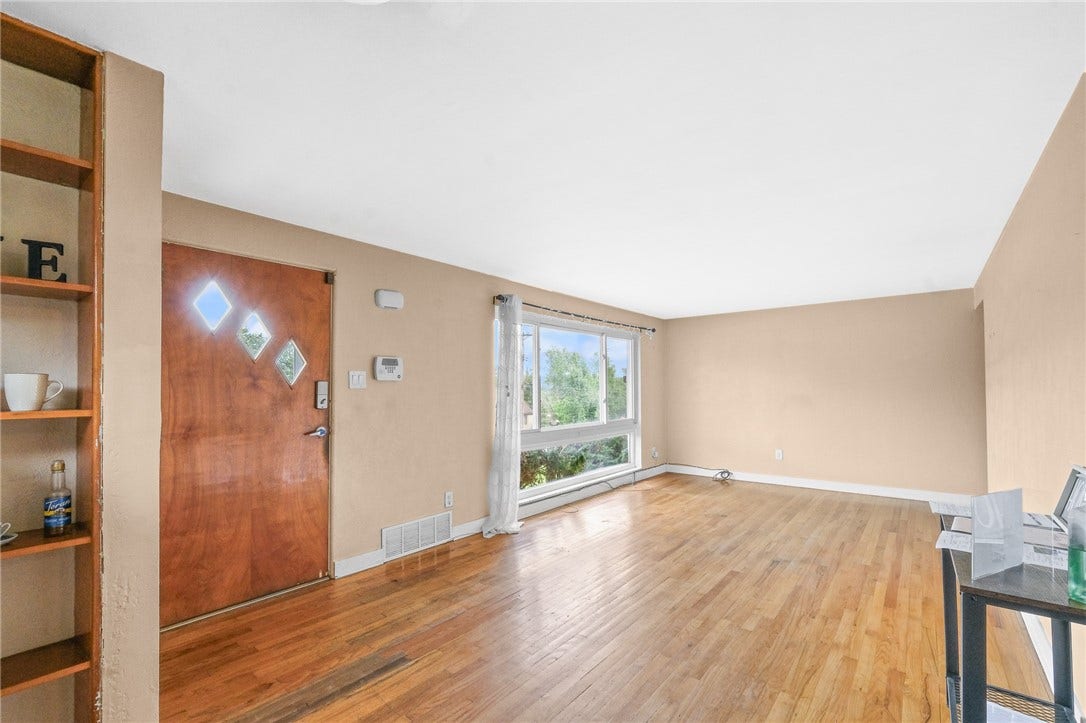 24 x 11 living/dining room combo features built-in shelving & hardwood floors.